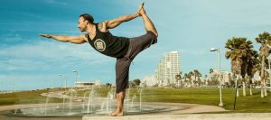 Eddy Toyonaga vinyasa yoga in dancers pose in the Tel Aviv