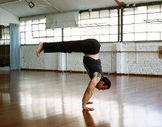Eddy Toyonaga in handstand pike pose in Naim Studio Tel Aviv