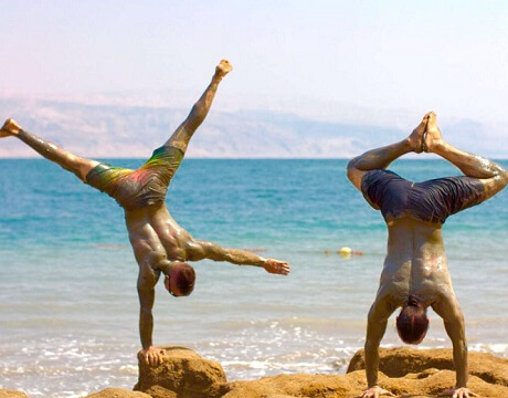 Eddy Toyonaga and Dylan Werner doing yoga at the Dead Sea
