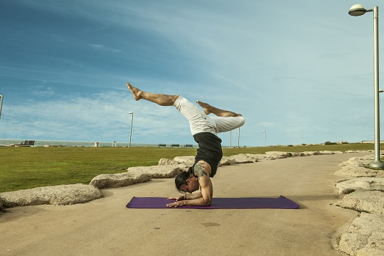 Eddy Toyonaga in Vrischikasana yoga pose in Tel Aviv