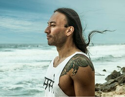 Eddy Toyonaga happy by the beach doing yoga meditation