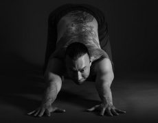 Eddy Toyonaga stretching on a black background