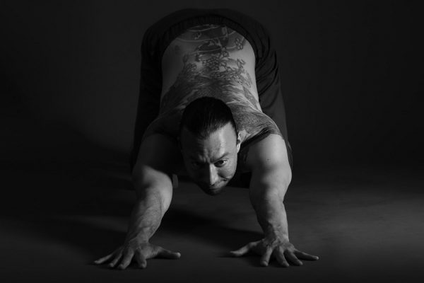 Eddy Toyonaga stretching on a black background