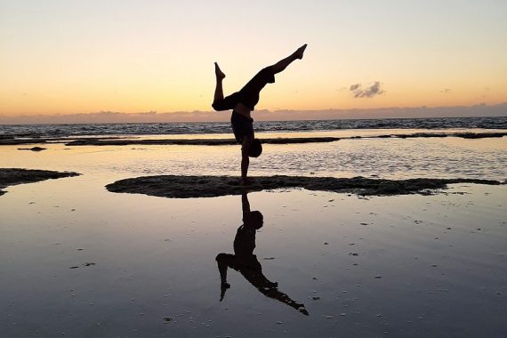Eddy Toyonaga handstand on beach at sunset