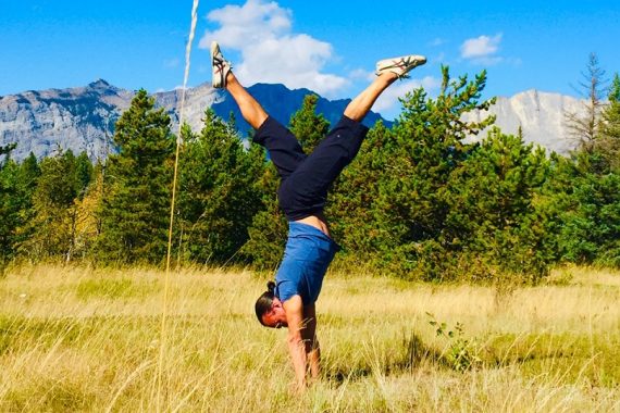 Eddy Toyonaga doing a handstand in the Rocky mountains